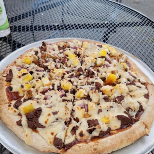 a pizza sitting on top of a plate of food