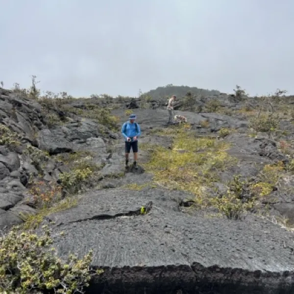 a man standing on a rocky hill