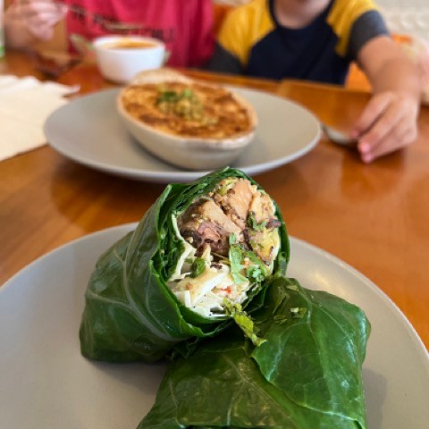a person sitting at a table with a plate of food