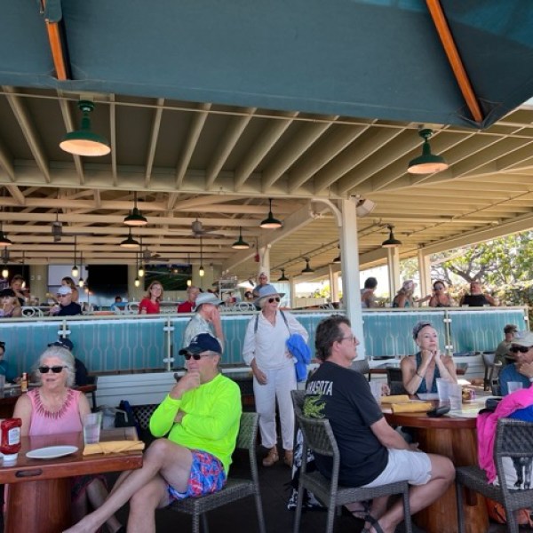 Tables inside a restaurant with people sittign and eating