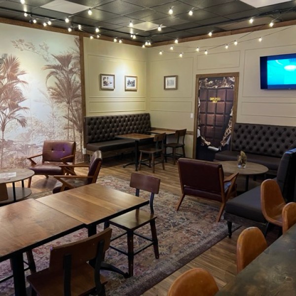 inside a restaurant filled with tables and couches