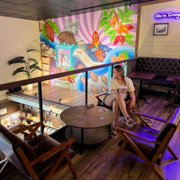 a person sitting at a table in a bar upper deck