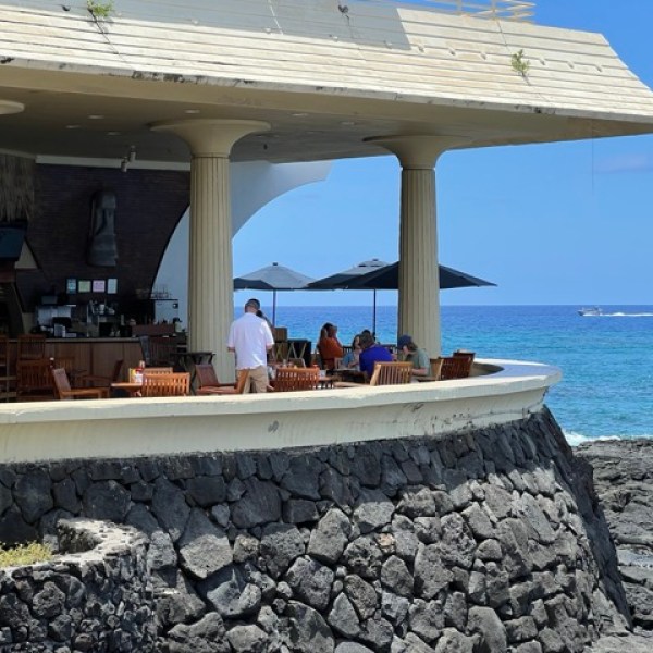 a group of people sitting at a beach