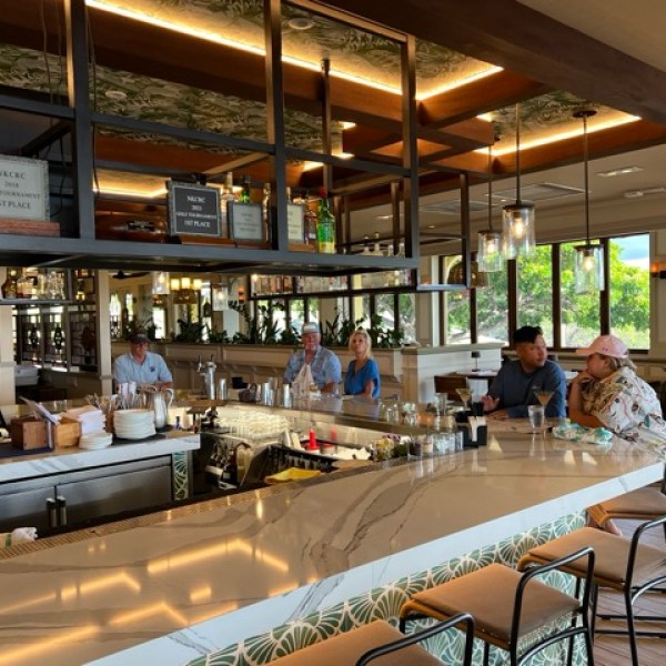 a group of people sitting at a table in a restaurant