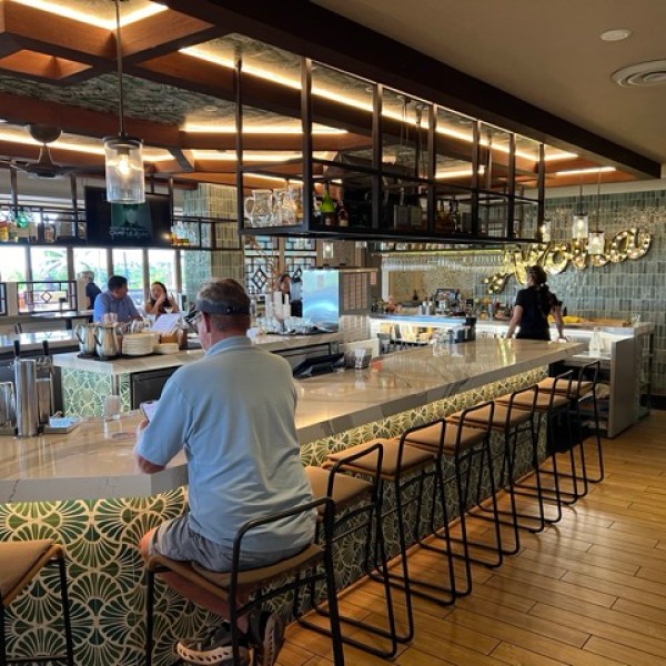 a person standing in front of a restaurant