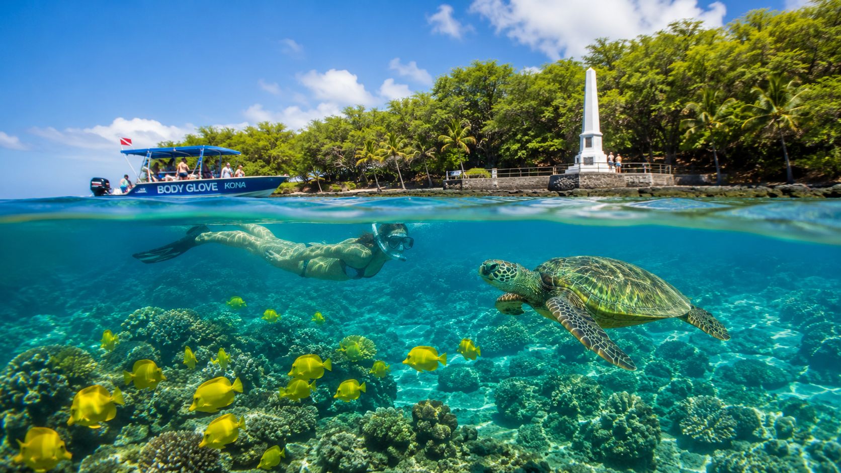 Snorkeler and turtle underwater with boat and monument in background.